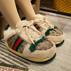 White sneakers with green and red accents worn by a person on a newspaper surface.